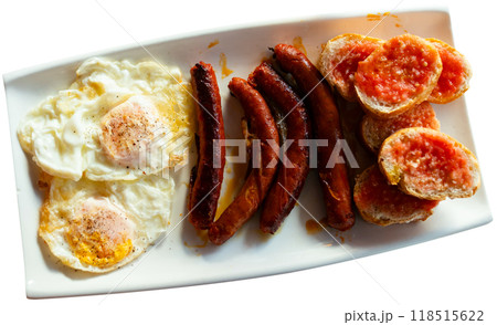 Fried eggs served with chistorra sausages 118515622