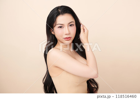 Beautiful young asian woman with clean fresh skin on beige background, Face care, Facial treatment, Cosmetology, beauty and spa, Asian women portrait. 118516460