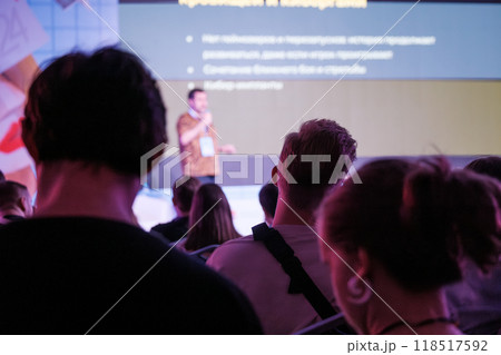 Audience attentively listening to speaker during business presentation Audience attentively listening to speaker during business presentation 118517592