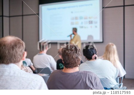 Audience attentively listening to a presentation in a conference setting Audience attentively listening to a presentation in a conference setting 118517593