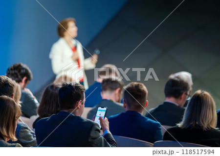 Speaker presenting at business conference with engaged audience Speaker presenting at business conference with engaged audience 118517594