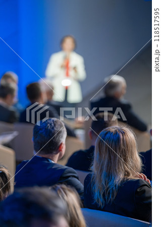 Business conference audience listening to speaker on stage Business conference audience listening to speaker on stage 118517595