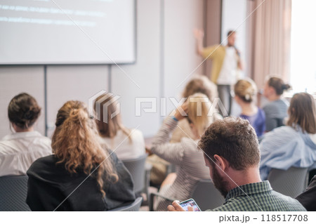 Business presentation with engaged audience in conference room Business presentation with engaged audience in conference room 118517708