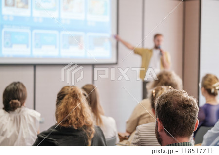 Business conference attendees listening to a presentation in a modern setting 118517711