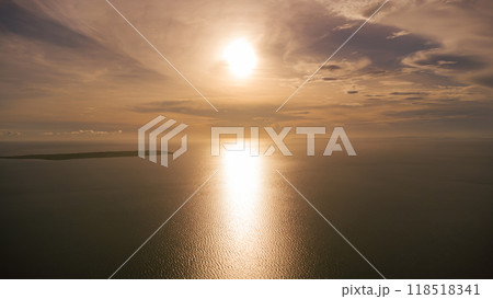 sunset over the ocean aerial view from high altitude, tropical islands in the sea sunset over the ocean aerial view from high altitude, tropical islands in the sea 118518341