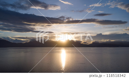 dawn over the sea against the backdrop of tropical mountains and clouds dawn over the sea against the backdrop of tropical mountains and clouds 118518342