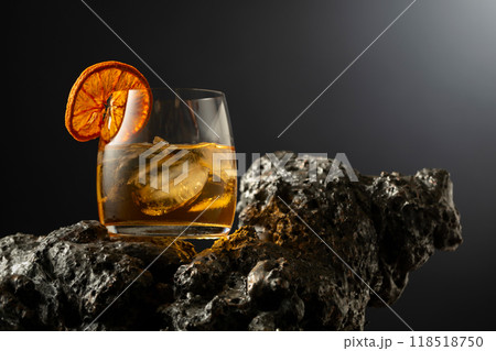 Old fashioned cocktail with ice and dried orange slice. Old fashioned cocktail with ice and dried orange slice. 118518750