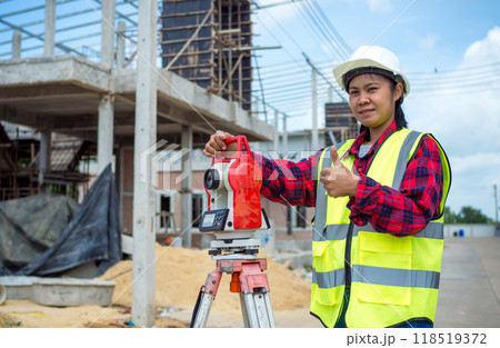 Surveyor and survey equipment on construction site, Land and soil development, Survey equipment, Theodolite for measurement construction work, Civil engineer or Architect working surveyor. 118519372