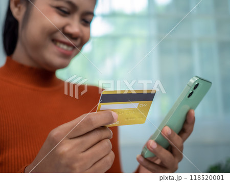Online banking transaction concept, Happy woman with credit card using smart phone and shopping online, Ecommerce and secure mobile banking concept, Making online payments. Online banking transaction concept, Happy woman with credit card using smart phone and shopping online, Ecommerce and secure mobile banking concept, Making online payments. 118520001