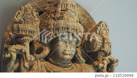 Close Up View On Statue Of Bhairava Or Frightful, Or Kala Bhairava, Is Shaivite And Vajrayana Deity Worshipped By Hindus And Buddhists. Antique Museum Piece Of Hoyasala Period, Karnataka 12th Century Close Up View On Statue Of Bhairava Or Frightful, Or Kala Bhairava, Is Shaivite And Vajrayana Deity Worshipped By Hindus And Buddhists. Antique Museum Piece Of Hoyasala Period, Karnataka 12th Century 118520098