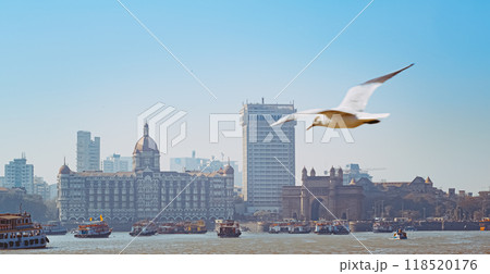 Mumbai, India. Many Boats with Tourists floating on the Arabian Sea. Tourists boats floating near Taj Mahal Palace hotel and Gateway of India. Cityscape skyline of Mumbai. Erected to commemorate the 118520176