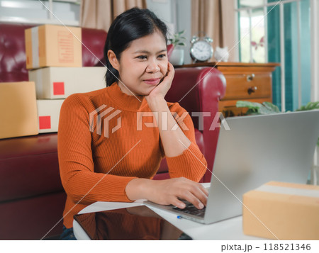Asia women working business SME online at home her checking order from laptop for customer and online delivery for ready packing, Checking orders from customers with digital laptop, Small business. Asia women working business SME online at home her checking order from laptop for customer and online delivery for ready packing, Checking orders from customers with digital laptop, Small business. 118521346