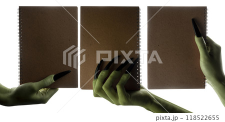 Set of witches hands holding notebooks for copy space. The hand color is green. Evil, zombie, or monster hand 118522655