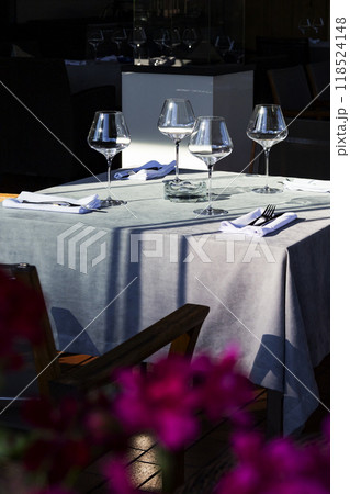 A beautiful table adorned with purple flowers positioned in the foreground A beautiful table adorned with purple flowers positioned in the foreground 118524148