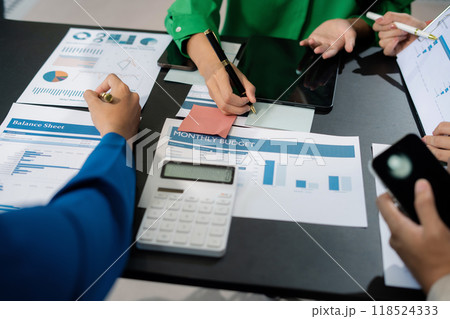 Close up Businessman and partner using calculator and laptop for calculation finance, tax, accounting, statistics and analytic research concept. in the office. 118524333