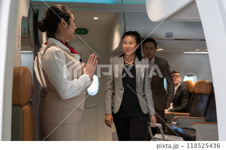 Air hostess or flight attendant standing at airplane entrance door and greeting passengers leaving airplane cabin Air hostess or flight attendant standing at airplane entrance door and greeting passengers leaving airplane cabin 118525436