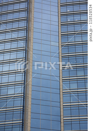 Glass facade of office skyscraper, exterior of modern building with glass cladding, vertical photo, multi storey building 118528534