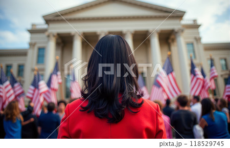Historic moment as newly elected first woman president walks into White House, surrounded by American flags. woman in suits, view from behind 118529745