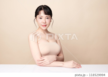 Beautiful young asian woman with clean fresh skin on beige background, Face care, Facial treatment, Cosmetology, beauty and spa, Asian women portrait. Beautiful young asian woman with clean fresh skin on beige background, Face care, Facial treatment, Cosmetology, beauty and spa, Asian women portrait. 118529994