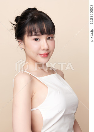 Beautiful young asian woman with clean fresh skin on beige background, Face care, Facial treatment, Cosmetology, beauty and spa, Asian women portrait. Beautiful young asian woman with clean fresh skin on beige background, Face care, Facial treatment, Cosmetology, beauty and spa, Asian women portrait. 118530008