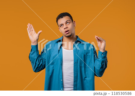 Irritated young multiracial man showing bla-bla gesture with hands, rolling eyes Irritated young multiracial man showing bla-bla gesture with hands, rolling eyes 118530586