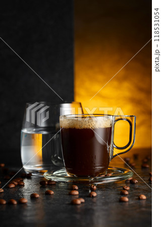 Espresso, glass of cold water, and roasted coffee beans. 118531054