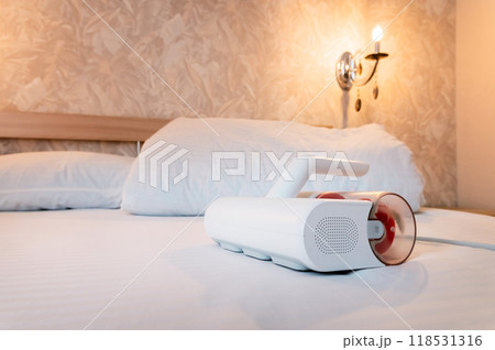Vacuum cleaner for cleaning mattresses from mites with UV lamp and knocking out dust. Cleaning and disinfection of the mattress in the bedroom Vacuum cleaner for cleaning mattresses from mites with UV lamp and knocking out dust. Cleaning and disinfection of the mattress in the bedroom 118531316