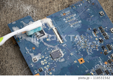 Top view. Technician cleaning motherboard. computer with cleaning solution 118531582