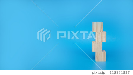 Cubic wooden block stacked on a blue background Cubic wooden block stacked on a blue background 118531837
