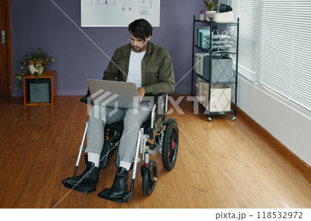 Man With Disability Using Laptop In Office Man With Disability Using Laptop In Office 118532972