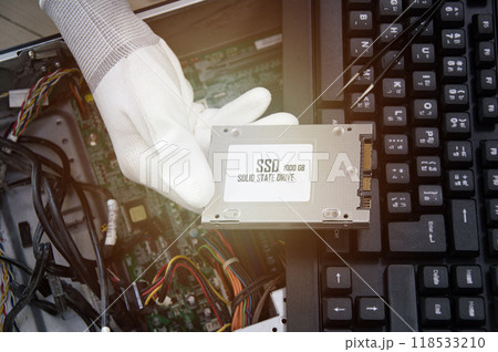 The technician is about to install an SSD drive in the computer. computer circuit repair 118533210