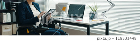 Woman With Disability Using Digital Tablet 118533449