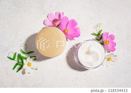 Cosmetic cream jar with delicate pink flowers Cosmetic cream jar with delicate pink flowers 118534415