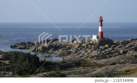 Cast iron Eigeroy lighthouse, rock formations and North Sea, Norway. 118534906