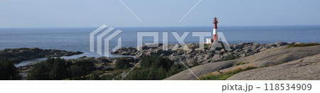 Cast iron Eigeroy lighthouse, rock formations and ocean, Norway. 118534909