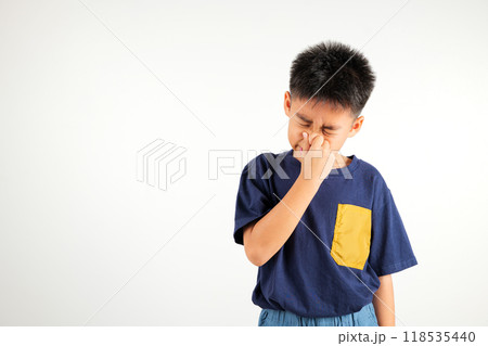 Asian young child unhappy what a smell disgust expression squeezing nose with fingers. Kid boy primary have something stinks bad smell situation, studio shot isolated on white background, Healthcare 118535440