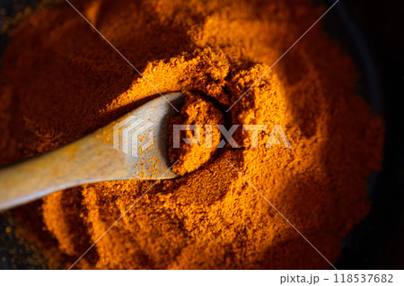 Very close up view of Paprika on a wooden spoon.Side light. 118537682