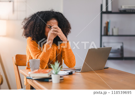 Stressed African American Woman at Desk with Laptop. Stressed African American Woman at Desk with Laptop. 118539695
