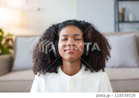 Close-up of African American Woman Relaxing with Headphones. 118539720