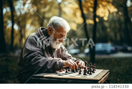 An elderly man engages in a game of chess, contemplating each move thoughtfully, surrounded by the tranquility of the outdoors, blending intellectual pursuit with the beauty of nature An elderly man engages in a game of chess, contemplating each move thoughtfully, surrounded by the tranquility of the outdoors, blending intellectual pursuit with the beauty of nature 118541330