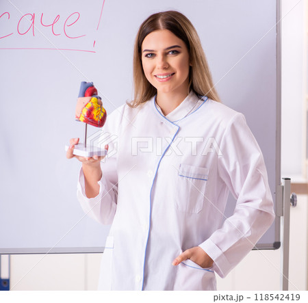 Young female doctor standing in front of the white board 118542419