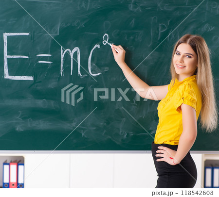 Young female student in front of the chalkboard 118542608