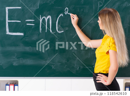 Young female student in front of the chalkboard Young female student in front of the chalkboard 118542610