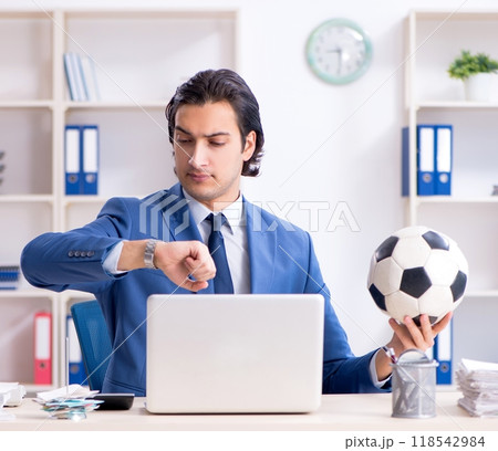 Young handsome businessman with soccer ball in the office Young handsome businessman with soccer ball in the office 118542984