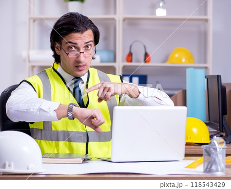 Young male architect working in the office 118543429