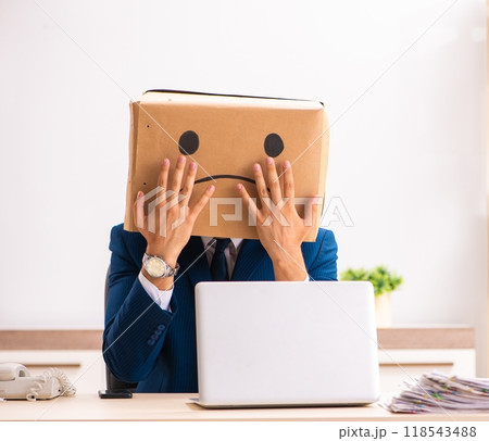 Unhappy man employee with box instead of his head 118543488