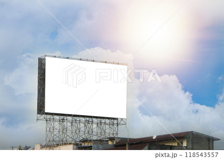 A large white billboard on the roadside 118543557