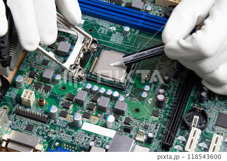 he close up image of technician squeezing the fresh thermal paste compound on the top of cpu in the socket. the concept of computer hardware, repairing, upgrade and technology. 118543600