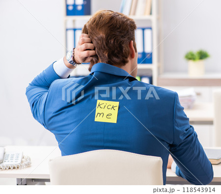Office prank with kick me message on sticky note Office prank with kick me message on sticky note 118543914