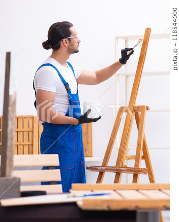 Young male contractor working in workshop Young male contractor working in workshop 118544000